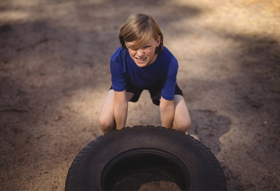 Kid flipping a big tire