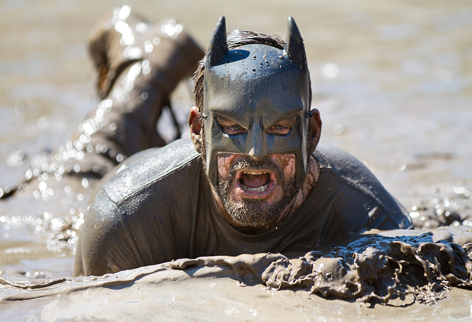 Runner wearing a costume at a mud race